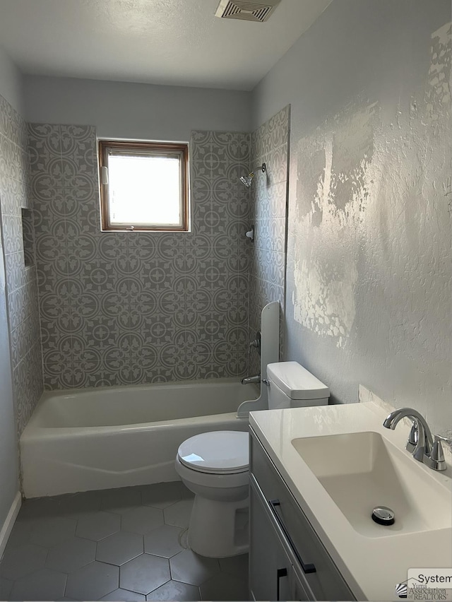 bathroom featuring vanity, a textured ceiling, shower / tub combination, toilet, and tile patterned floors