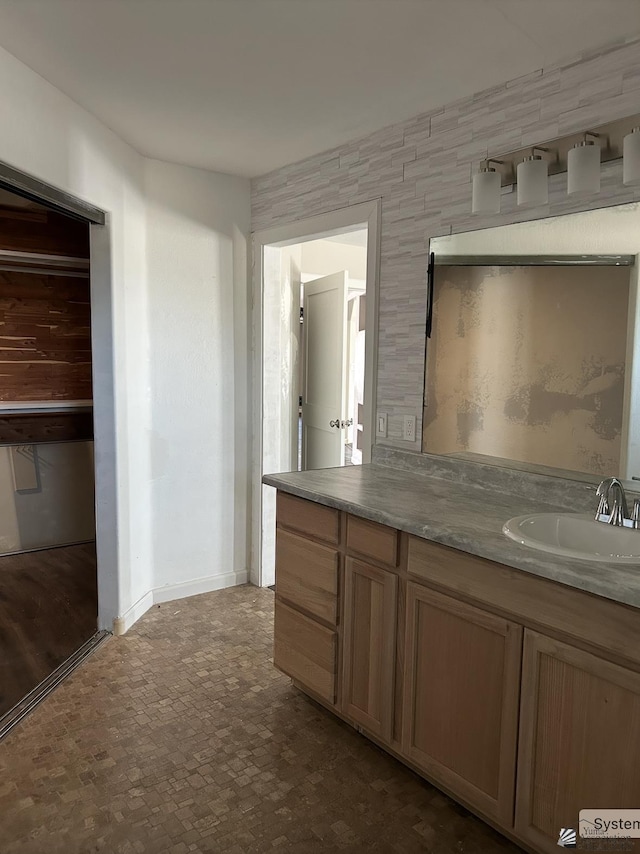 bathroom featuring baseboards and vanity