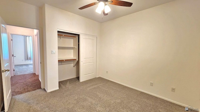 unfurnished bedroom featuring carpet floors, a closet, a ceiling fan, and baseboards