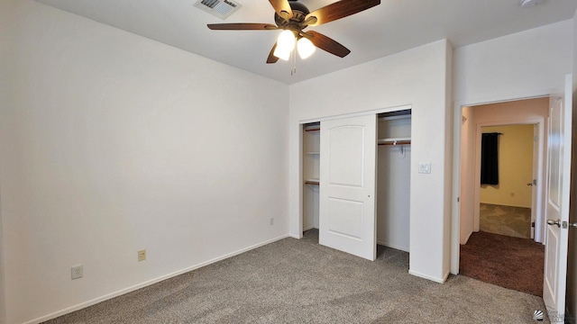 unfurnished bedroom featuring baseboards, a closet, visible vents, and carpet flooring