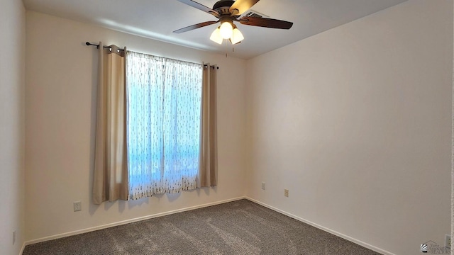 carpeted empty room with ceiling fan and baseboards