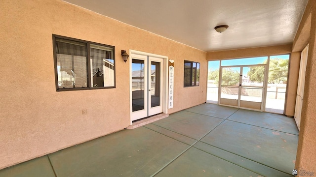 unfurnished sunroom featuring french doors