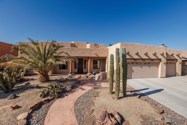 pueblo-style home with a garage