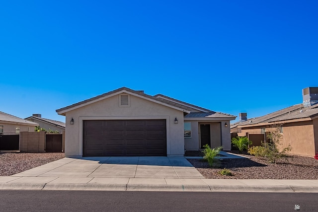 single story home with a garage, fence, concrete driveway, and stucco siding