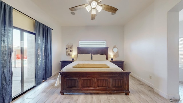 bedroom featuring light wood-style flooring, baseboards, ceiling fan, and access to outside