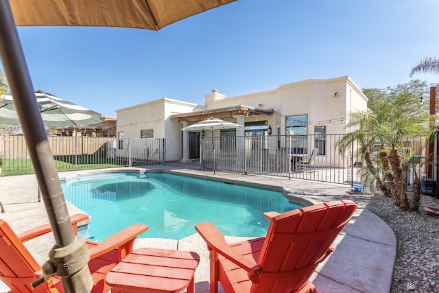 view of swimming pool with a patio area, fence, and a fenced in pool