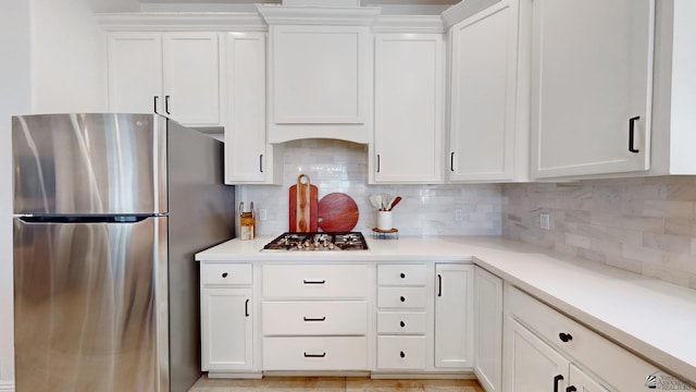 kitchen featuring white cabinets, stainless steel appliances, and light countertops