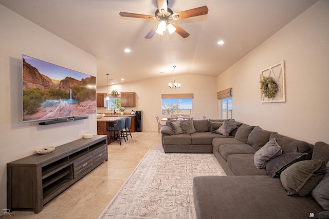 living room featuring ceiling fan with notable chandelier, lofted ceiling, and recessed lighting