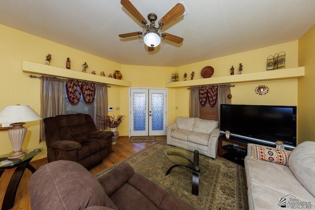 living room with hardwood / wood-style floors, ceiling fan, and french doors