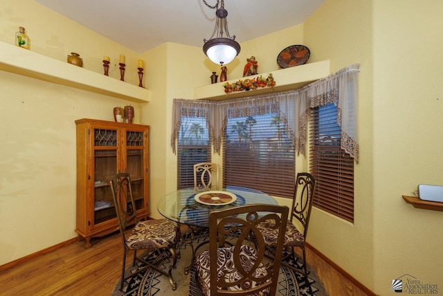 dining space with wood-type flooring