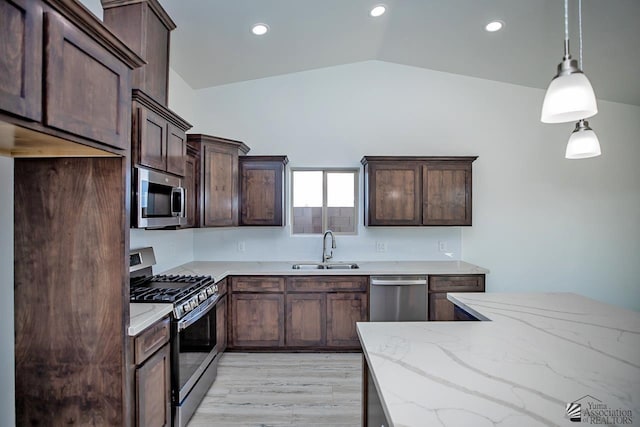 kitchen featuring decorative light fixtures, sink, dark brown cabinetry, light stone countertops, and stainless steel appliances