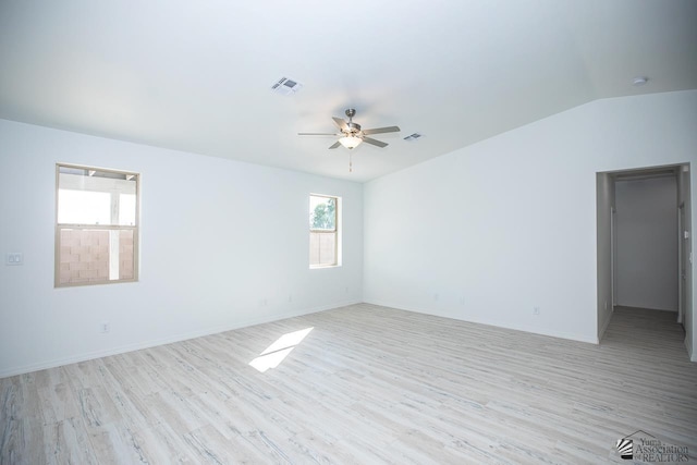 unfurnished room with ceiling fan, light wood-type flooring, and vaulted ceiling