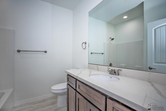 full bathroom with toilet, shower / tub combination, hardwood / wood-style floors, and vanity