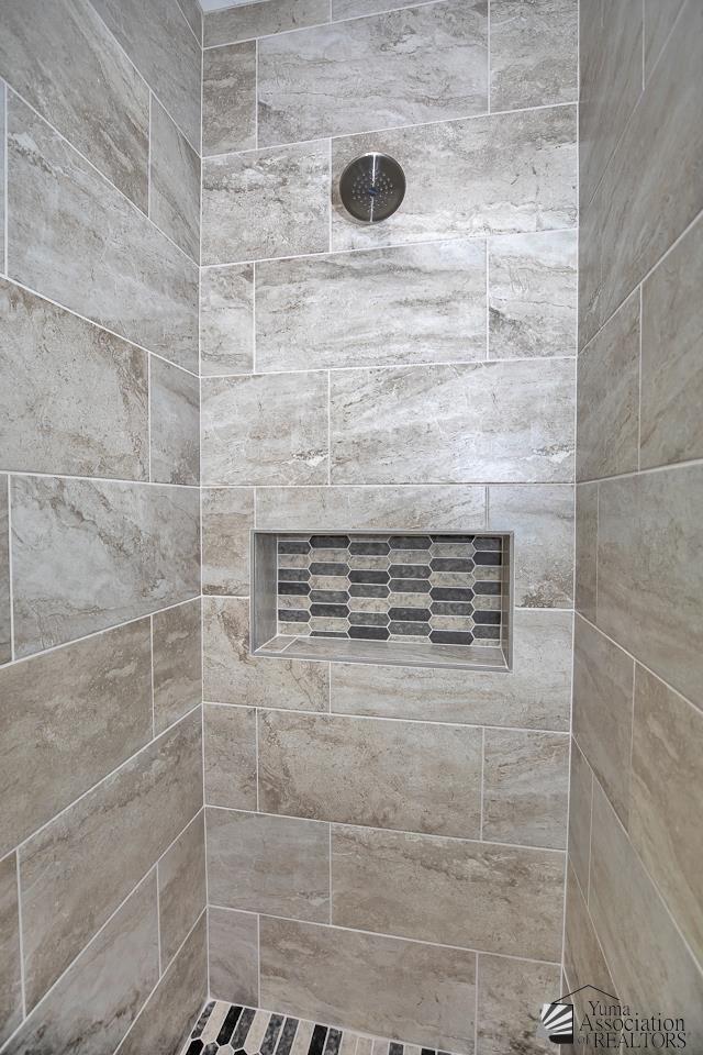 bathroom with a tile shower