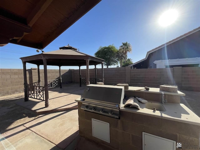 view of patio / terrace with a gazebo, exterior kitchen, and grilling area