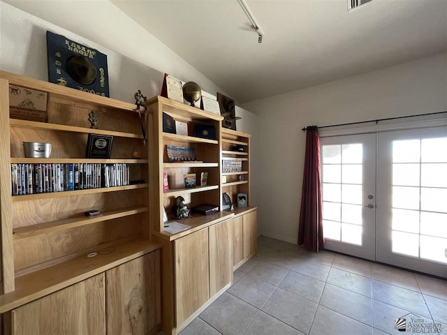 interior space featuring french doors and track lighting