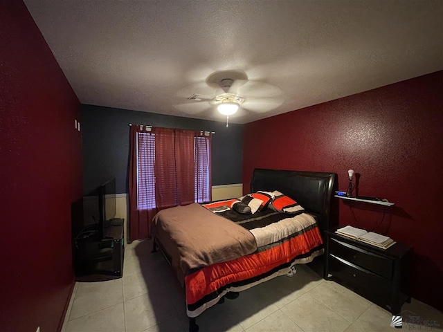 tiled bedroom with ceiling fan