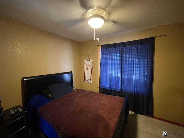 tiled bedroom with ceiling fan