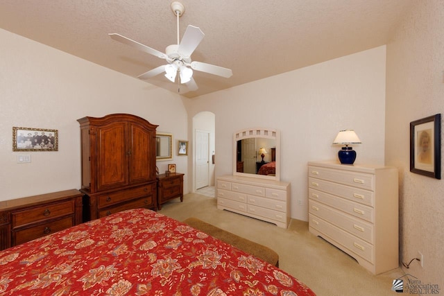 carpeted bedroom featuring a textured ceiling and ceiling fan