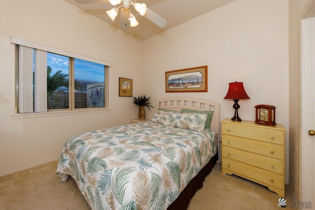 bedroom featuring vaulted ceiling, light colored carpet, and ceiling fan