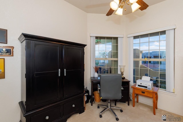 home office featuring light carpet and ceiling fan