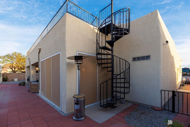 view of property exterior with a patio area