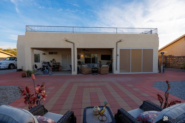 back of house featuring outdoor lounge area, a patio, and a balcony