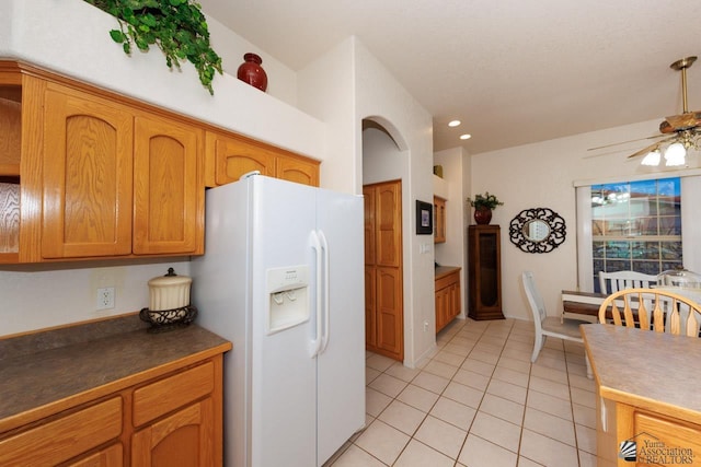 kitchen with white refrigerator with ice dispenser, ceiling fan, and light tile patterned flooring