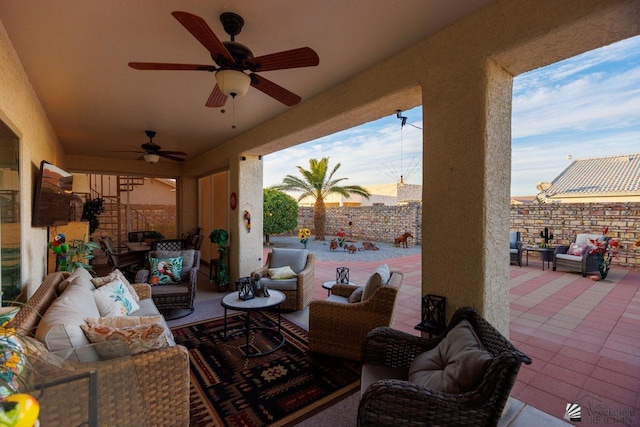 patio terrace at dusk featuring ceiling fan and outdoor lounge area