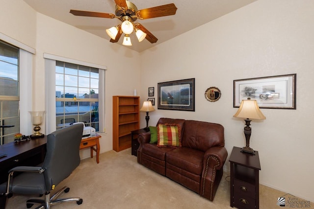 office space with light carpet and ceiling fan