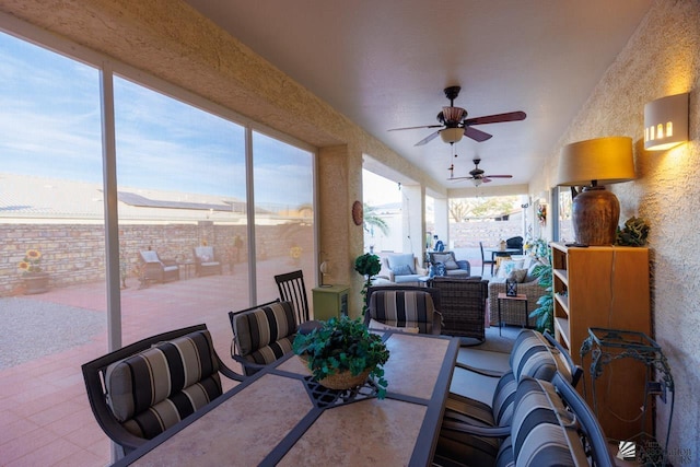 sunroom / solarium featuring ceiling fan