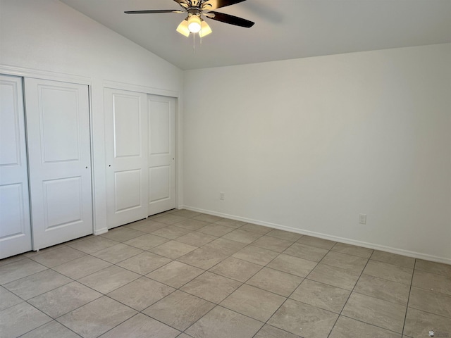 unfurnished bedroom with light tile patterned flooring, ceiling fan, and lofted ceiling