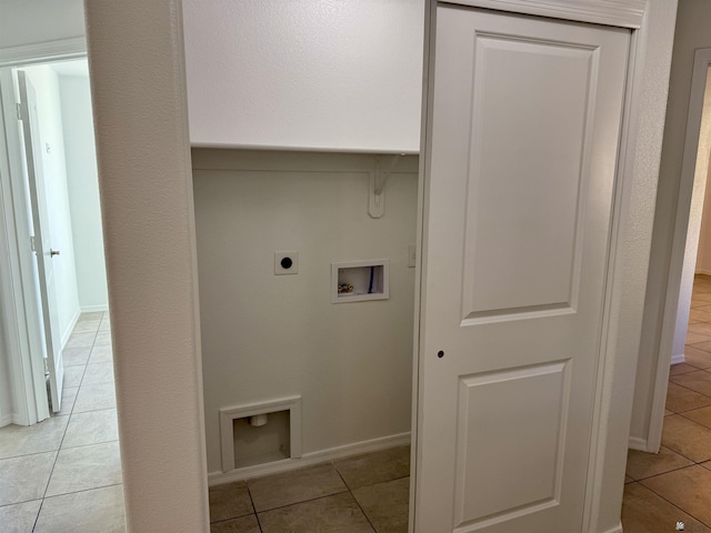 laundry area featuring washer hookup, electric dryer hookup, and light tile patterned flooring