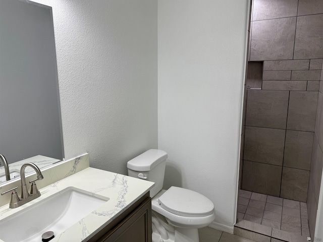 bathroom with tile patterned floors, vanity, and toilet