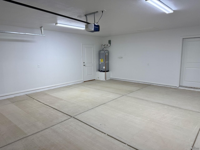 garage with gas water heater and a garage door opener