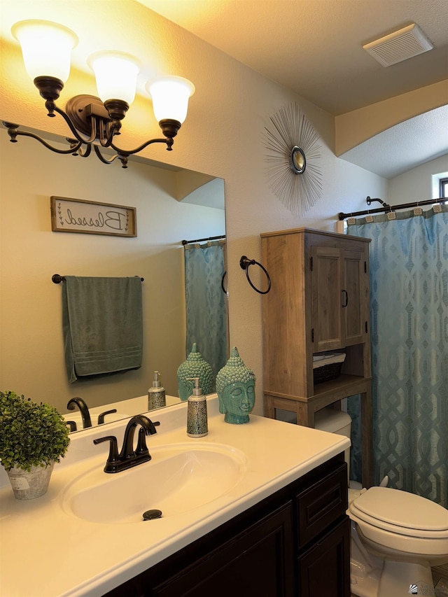 bathroom featuring walk in shower, vanity, toilet, and a chandelier