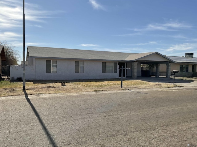 single story home with a carport