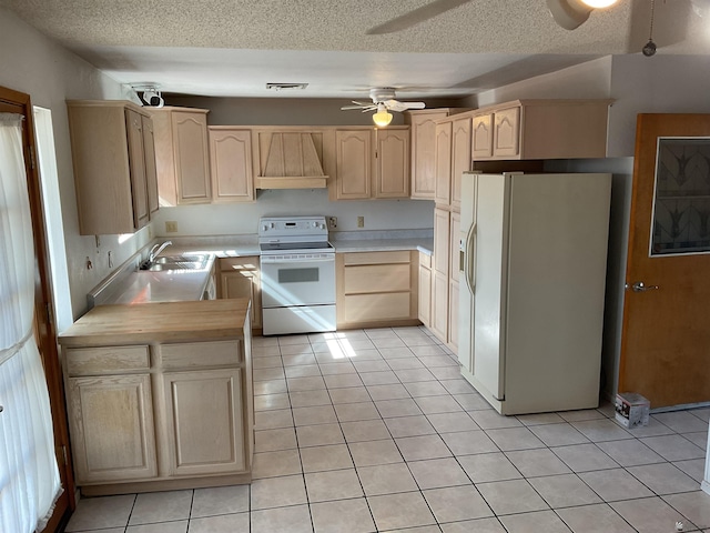 kitchen with premium range hood, light tile patterned flooring, light brown cabinetry, sink, and white appliances