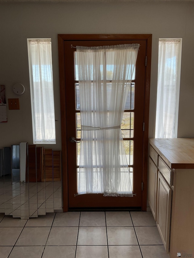 entryway with light tile patterned floors and a healthy amount of sunlight