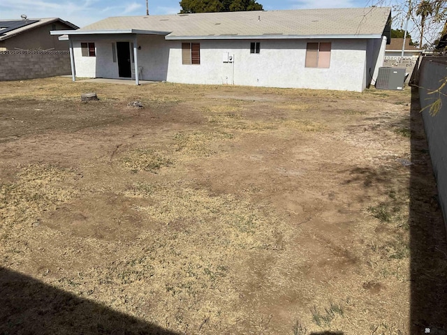 back of house featuring central AC unit