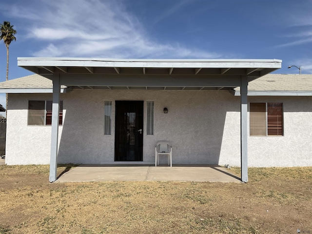 rear view of property with a yard and a patio area