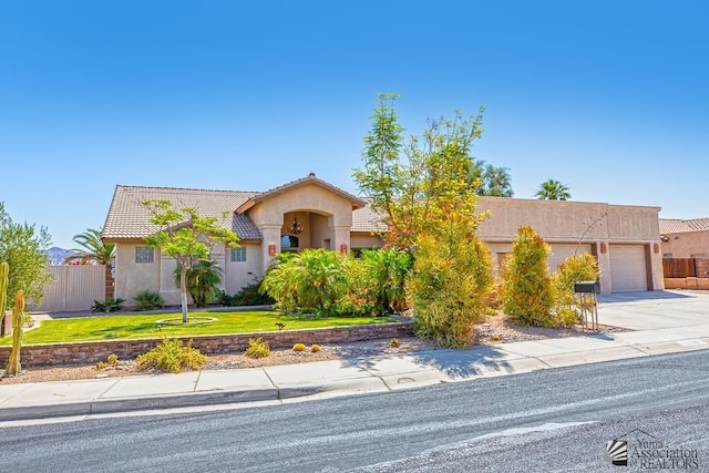 10243 Fairway Loop, Yuma, AZ 85367 - view of front of house with a garage, stucco siding, concrete driveway, and a tile roof