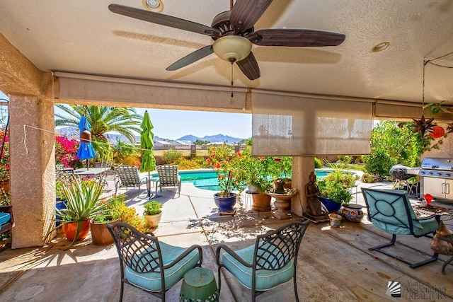 10243 Fairway Loop, Yuma, AZ 85367 - view of patio / terrace with an outdoor pool, a ceiling fan, a mountain view, a grill, and outdoor dining area