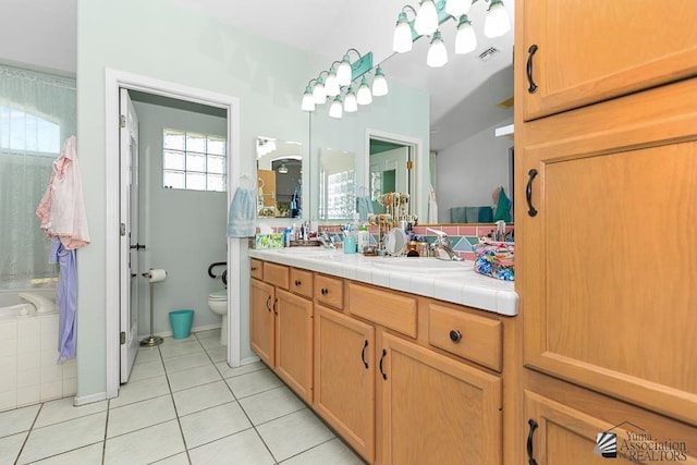 10243 Fairway Loop, Yuma, AZ 85367 - bathroom with tile patterned floors, toilet, double vanity, and a tub to relax in