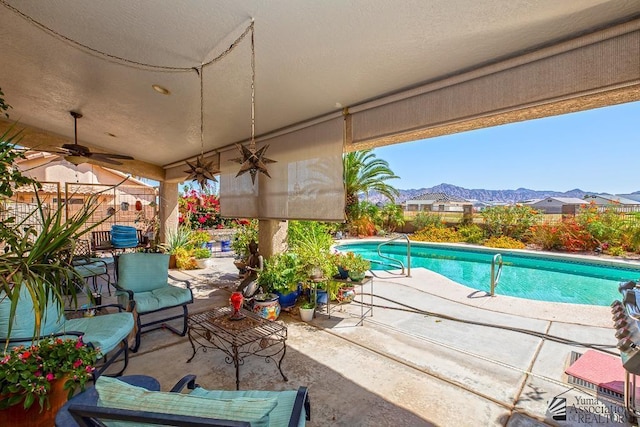 10243 Fairway Loop, Yuma, AZ 85367 - view of patio / terrace with a ceiling fan, a mountain view, and fence