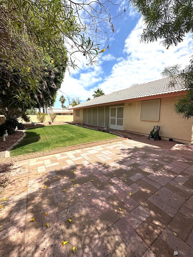 12385 E Del Rico, Yuma, AZ 85367 - back of property featuring a patio area, a tile roof, stucco siding, and a lawn