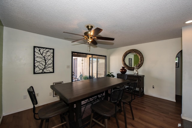 660 E 26th St, Yuma, AZ 85365 - dining area with wood finished floors, a textured ceiling, a ceiling fan, baseboards, and arched walkways