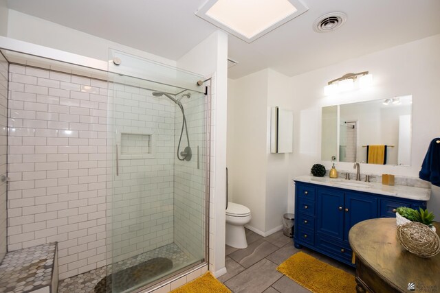 660 E 26th St, Yuma, AZ 85365 - bathroom featuring a tile shower, toilet, vanity, and tile patterned floors