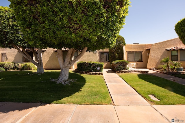 660 E 26th St, Yuma, AZ 85365 - view of front facade featuring stucco siding and a front lawn