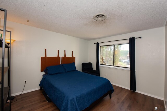 660 E 26th St, Yuma, AZ 85365 - bedroom with wood finished floors, baseboards, and a textured ceiling
